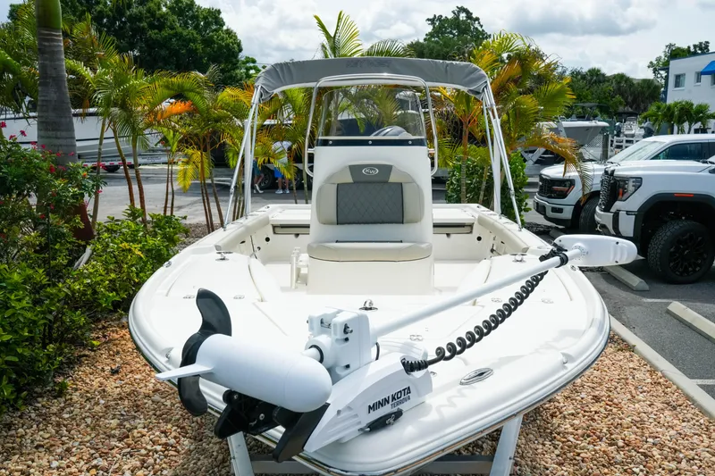 Slide: The Image of 2025 Key West 210 Bay Reef boat with Minn Kota motor, parked outdoors. - 8