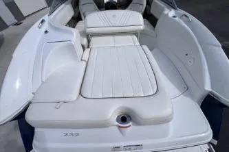 Slide: The Image of 2007 Cobalt 232 boat interior with white cushioned seating and sleek design. - 10