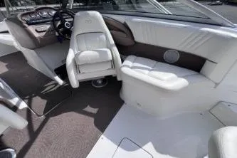 Slide: The Image of 2007 Cobalt 232 boat interior with white seating and steering wheel. - 13