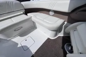 Slide: The Image of Interior of a 2007 Cobalt 232 boat featuring white seating and storage compartments. - 14