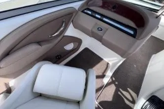 Slide: The Image of Interior of a 2007 Cobalt 232 boat, featuring beige and white seating. - 15