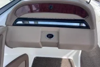 Slide: The Image of 2007 Cobalt 232 boat dashboard with beige and wood accents. - 16