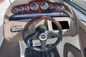 Slide: The Image of 2007 Cobalt 232 boat dashboard with gauges and steering wheel. - 18