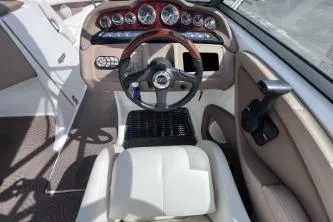 Slide: The Image of Interior of a 2007 Cobalt 232 boat featuring steering wheel and dashboard controls. - 19