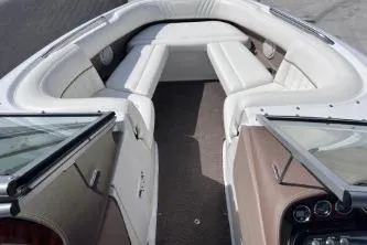 Slide: The Image of 2007 Cobalt 232 boat interior with white seating and dashboard view. - 21