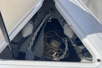 Slide: The Image of Anchor storage compartment on a 2007 Cobalt 232 boat with chain and rope. - 22