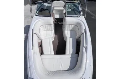 Slide: The Image of 2007 Cobalt 232 boat interior with white leather seating and open bow design. - 23