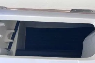Slide: The Image of Storage compartment of a 2007 Cobalt 232 boat, featuring a sleek white interior. - 24