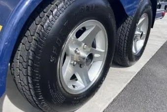 Slide: The Image of Trailer wheels of a 2007 Cobalt 232 boat on a concrete surface. - 29