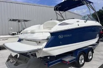 Slide: The Image of 2007 Cobalt 232 boat with blue hull on a trailer, parked outdoors. - 5