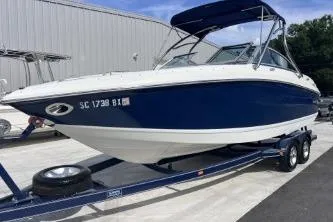 Slide: The Image of 2007 Cobalt 232 boat on trailer, blue and white exterior, parked outdoors. - 7