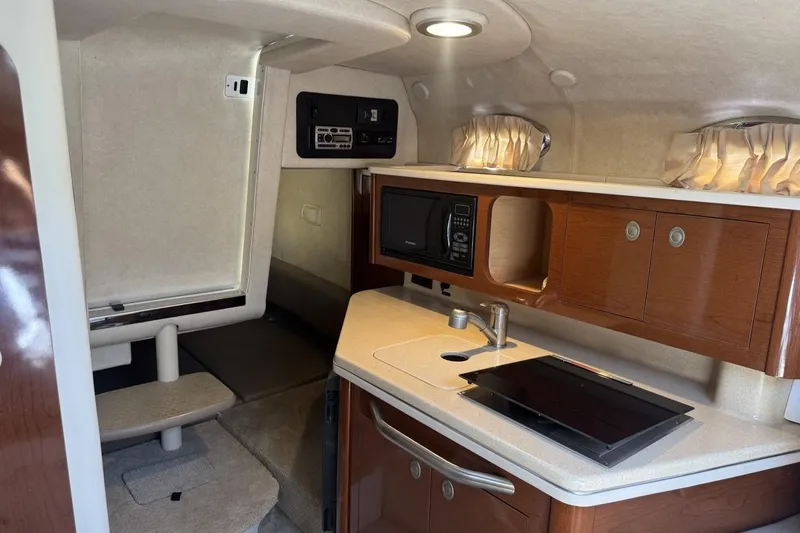 Slide: The Image of Interior of 2008 Sea Ray Sundancer 260 with kitchenette and seating area. - 37