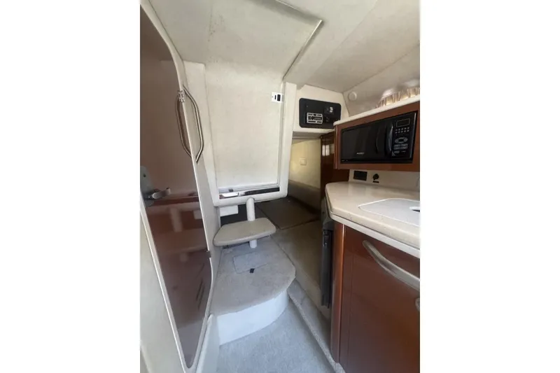 Slide: The Image of 2008 Sea Ray Sundancer 260 cabin interior with kitchenette and seating area. - 32