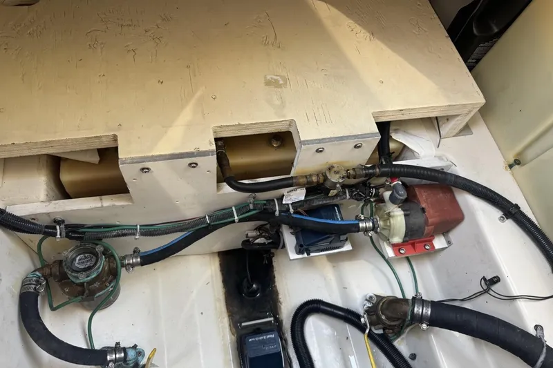 Slide: The Image of Engine compartment of a 2008 Sea Ray Sundancer 260, showcasing mechanical components and hoses. - 45