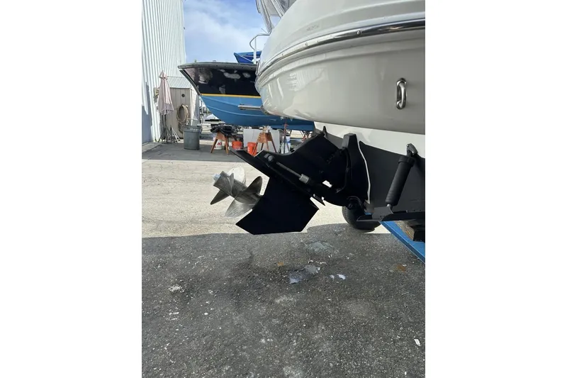 Slide: The Image of 2008 Sea Ray Sundancer 260 boat propeller and stern drive in a marina setting. - 25