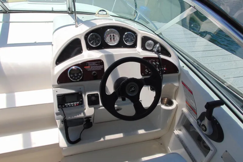 Slide: The Image of Cockpit of 2008 Sea Ray Sundancer 260 with steering wheel and control panel. - 10