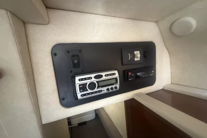 Slide: The Image of 2008 Sea Ray Sundancer 260 cabin control panel with stereo and switches. - 34