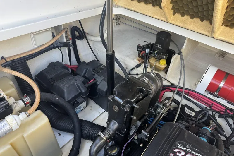 Slide: The Image of Engine compartment of a 2008 Sea Ray Sundancer 260, showcasing mechanical components and wiring. - 42