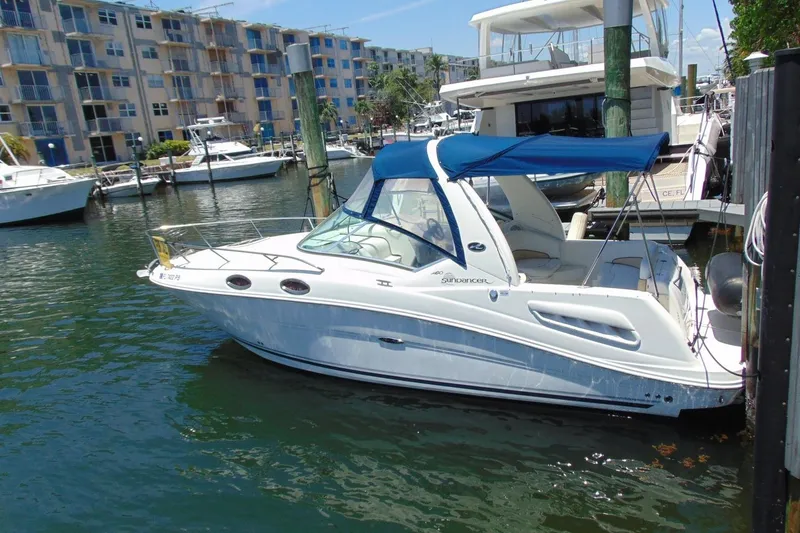 Slide: The Image of 2008 Sea Ray Sundancer 260 docked at marina with blue canopy. - 5