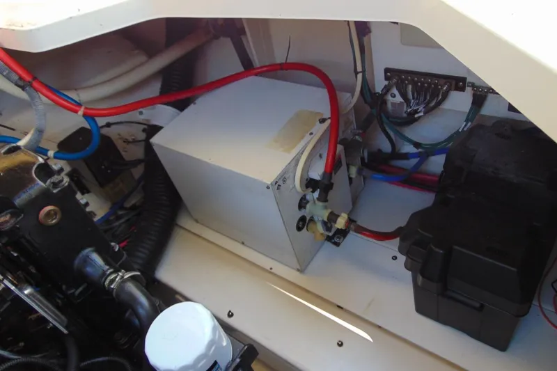 Slide: The Image of Engine compartment of a 2008 Sea Ray Sundancer 260 with visible wiring and components. - 14