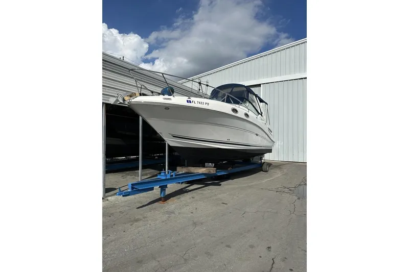 Slide: The Image of 2008 Sea Ray Sundancer 260 boat on trailer, parked outside a storage facility. - 23
