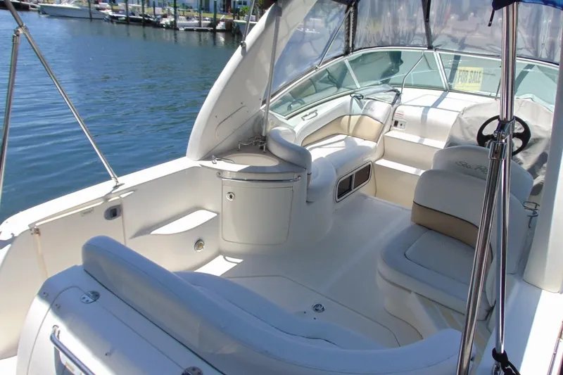 Slide: The Image of 2008 Sea Ray Sundancer 260 boat interior with seating, steering wheel, and waterfront view. - 7