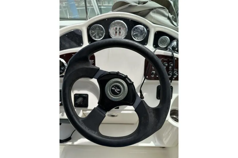 Slide: The Image of Steering wheel and dashboard of 2008 Sea Ray Sundancer 260 boat. - 21