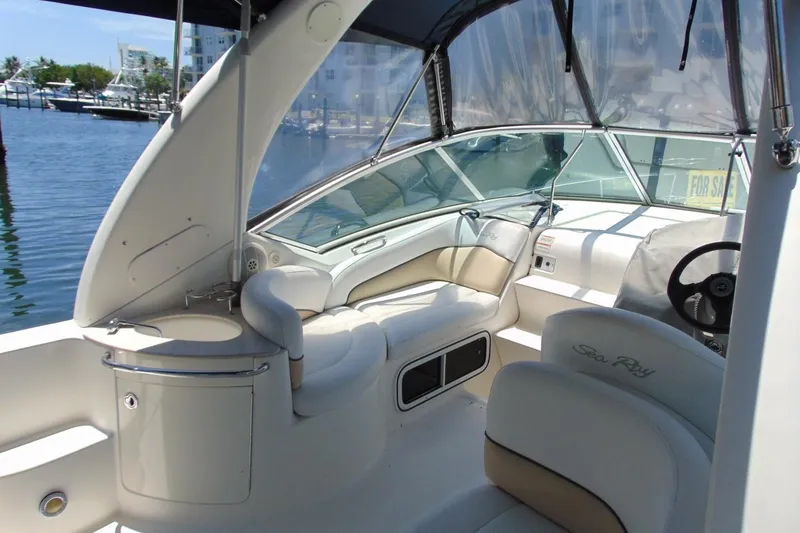 Slide: The Image of 2008 Sea Ray Sundancer 260 interior with helm, seating, and waterfront view. - 8