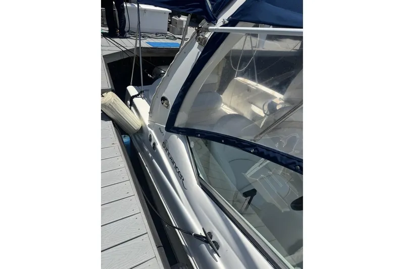Slide: The Image of 2008 Sea Ray Sundancer 260 docked, featuring sleek design and clear canopy. - 50