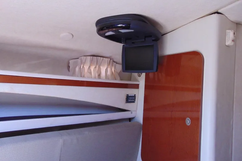 Slide: The Image of Interior of 2008 Sea Ray Sundancer 260 with TV and wooden cabinetry. - 11