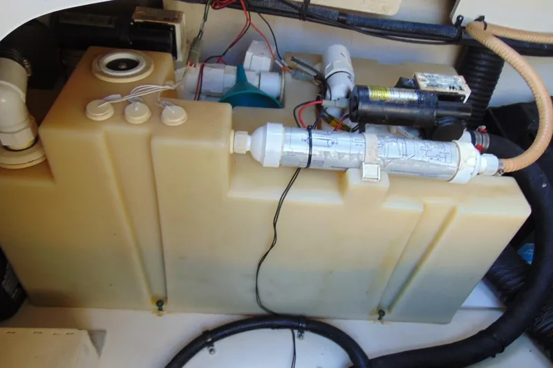 Slide: The Image of Engine compartment of a 2008 Sea Ray Sundancer 260 boat, showing water tank and components. - 15