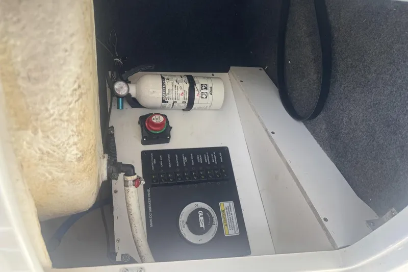 Slide: The Image of 2008 Sea Ray Sundancer 260 engine compartment with fire extinguisher and control panel. - 36