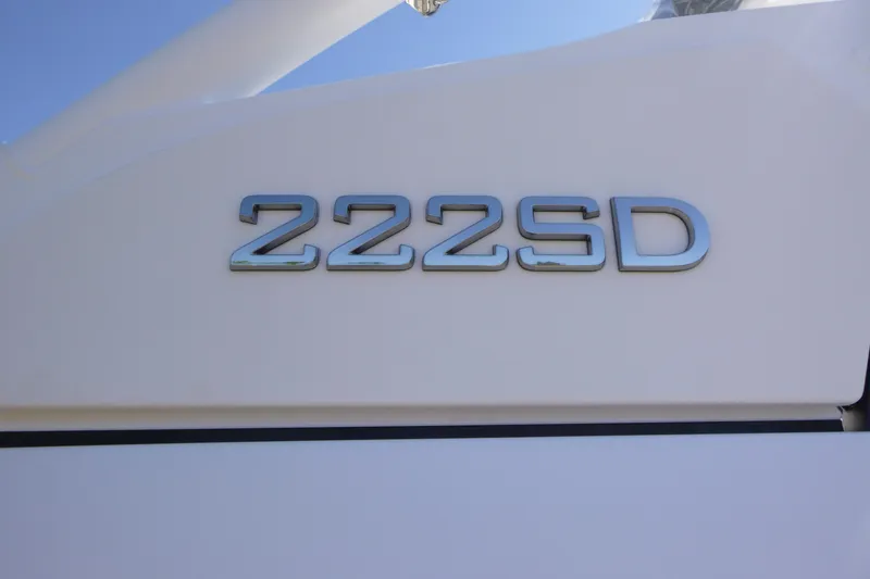 Slide: The Image of Close-up of 2026 Yamaha Boats 222SD model emblem on white surface. - 18