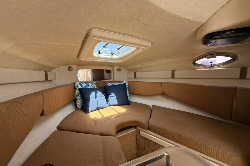 Slide: The Image of Interior cabin of 2009 Sea Ray 240 Sundancer with cozy seating and skylight. - 12