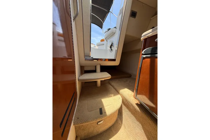 Slide: The Image of Interior view of 2009 Sea Ray 240 Sundancer cabin with carpeted steps and wooden cabinetry. - 20