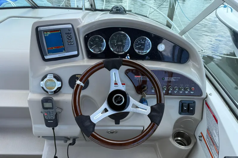 Slide: The Image of Steering console of a 2009 Sea Ray 240 Sundancer with gauges and navigation equipment. - 5
