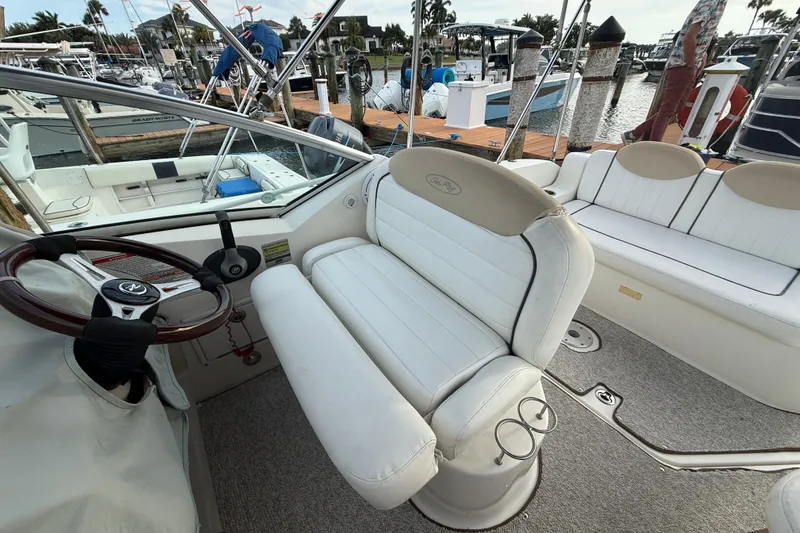 Slide: The Image of Interior view of a 2009 Sea Ray 240 Sundancer boat at a marina. - 8