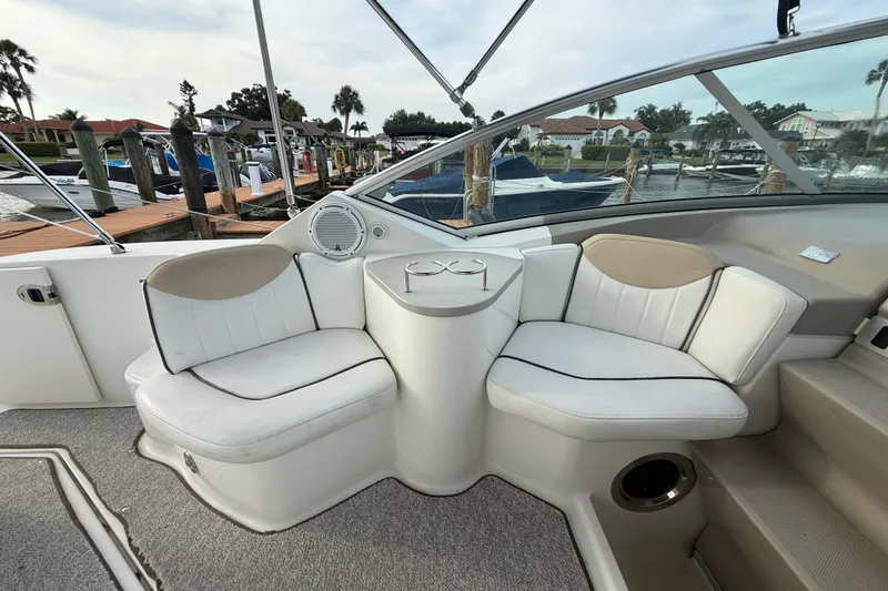 Slide: The Image of 2009 Sea Ray 240 Sundancer boat interior with white seating and cup holders. - 9