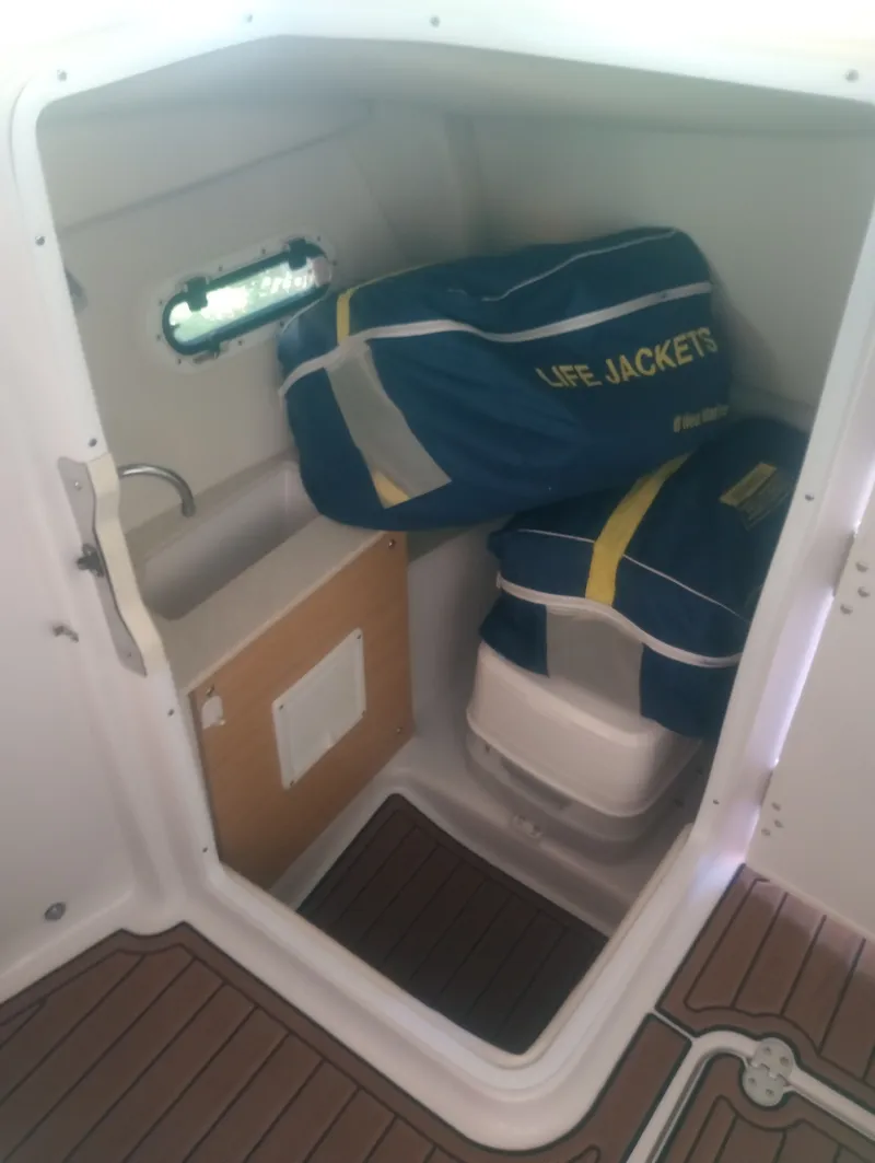 Slide: The Image of Interior of 2013 Four Winns H260 boat with life jackets. - 20