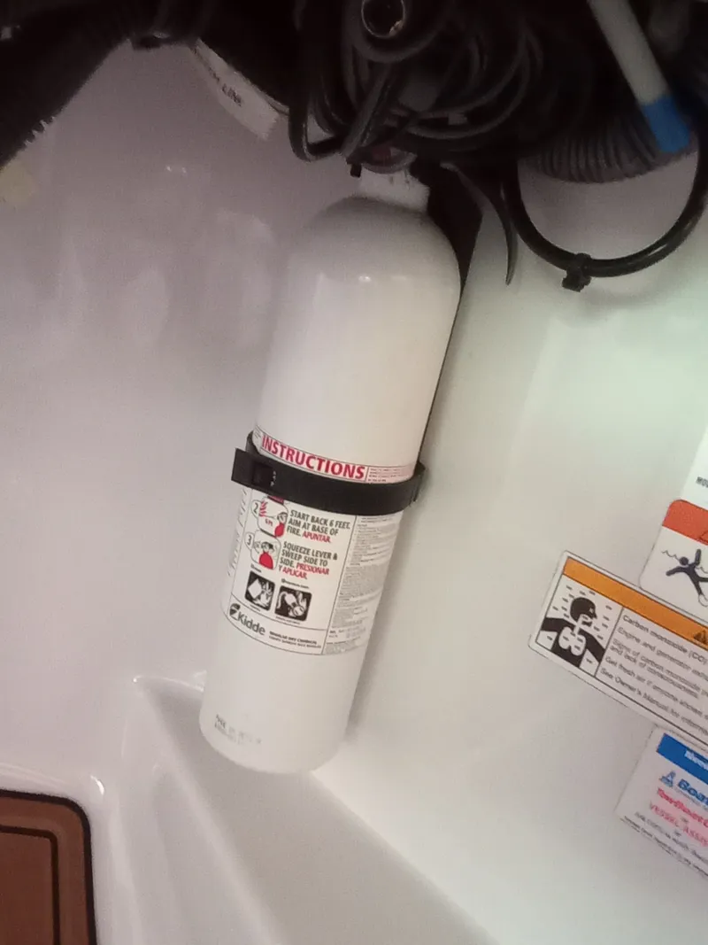 Slide: The Image of Fire extinguisher mounted in a 2013 Four Winns H260 boat. - 21