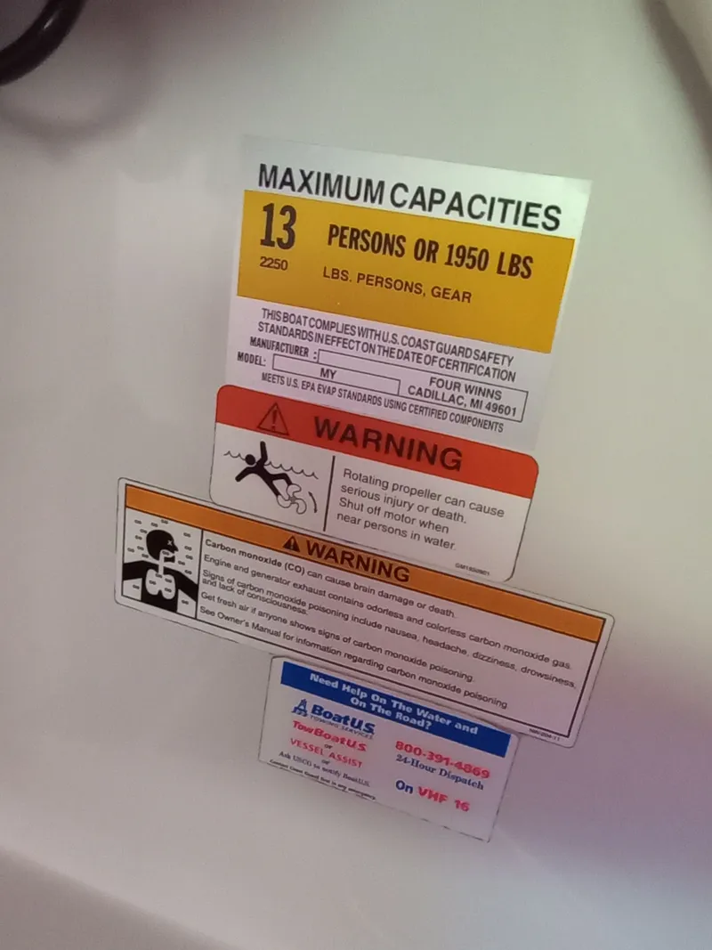 Slide: The Image of Warning labels on a 2013 Four Winns H260 boat. - 22