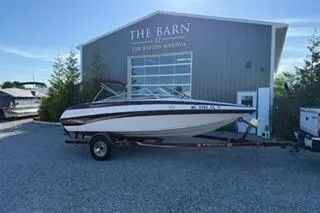 The Image of 2006 Crownline 180 BR boat on trailer outside The Barn building. - 1