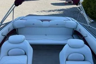 Slide: The Image of 2006 Crownline 180 BR boat interior with white seating and open deck layout. - 9