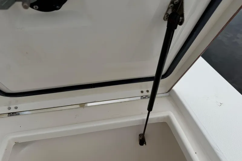 Slide: The Image of Open storage compartment on a 2002 Regulator 32 Forward Seating boat. - 11