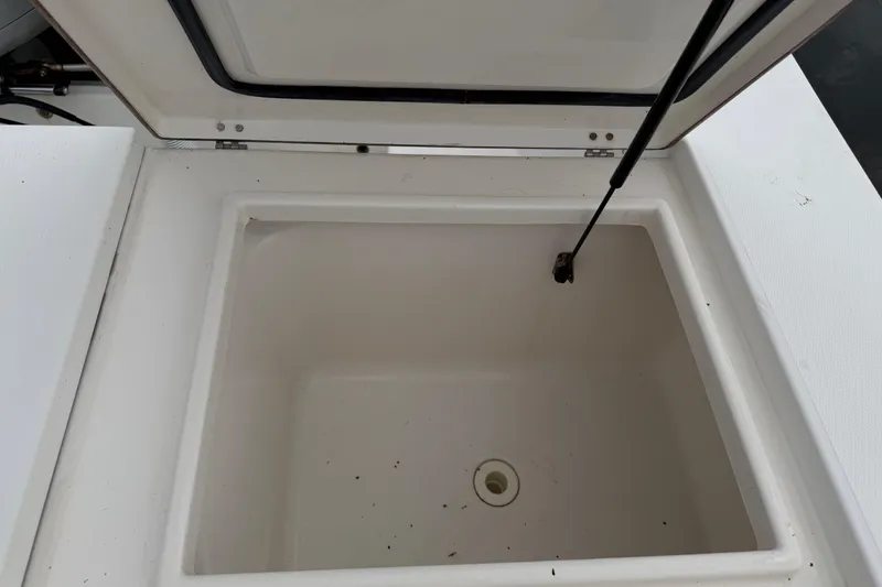 Slide: The Image of Open storage compartment on 2002 Regulator 32 Forward Seating boat. - 12