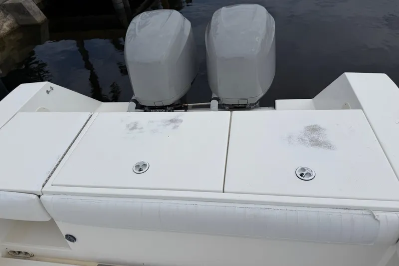 Slide: The Image of 2002 Regulator 32 Forward Seating boat with dual outboard motors, docked by the water. - 13