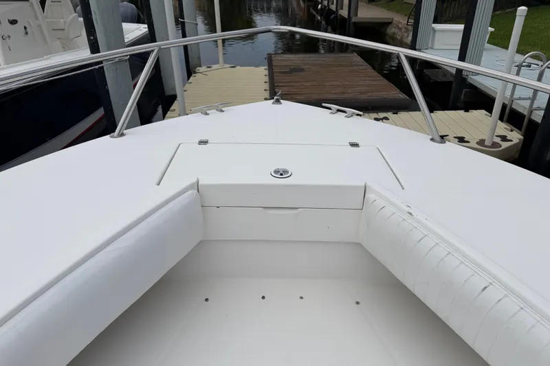 Slide: The Image of 2002 Regulator 32 Forward Seating boat, white interior, docked at marina. - 14