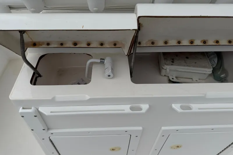 Slide: The Image of Open storage compartments on a 2002 Regulator 32 Forward Seating boat. - 20