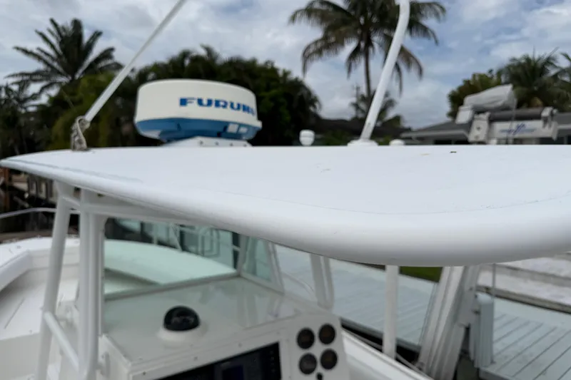 Slide: The Image of 2002 Regulator 32 Forward Seating boat with radar, palm trees in background. - 23