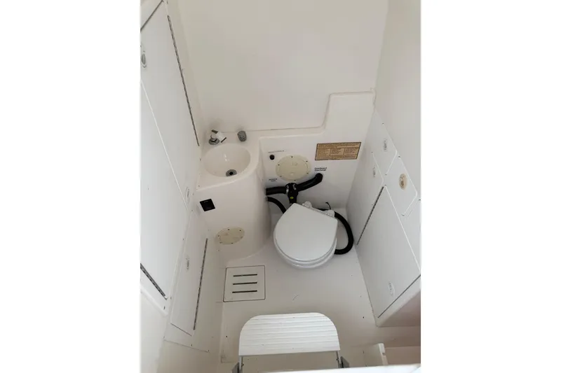 Slide: The Image of 2002 Regulator 32 Forward Seating boat interior with compact bathroom amenities. - 25